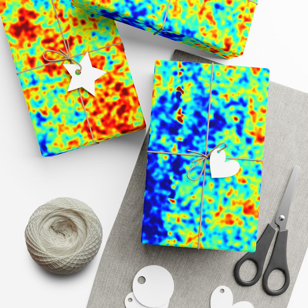 Colorful cosmic microwave backround pattern gift wrap with scissors and yarn on a white surface