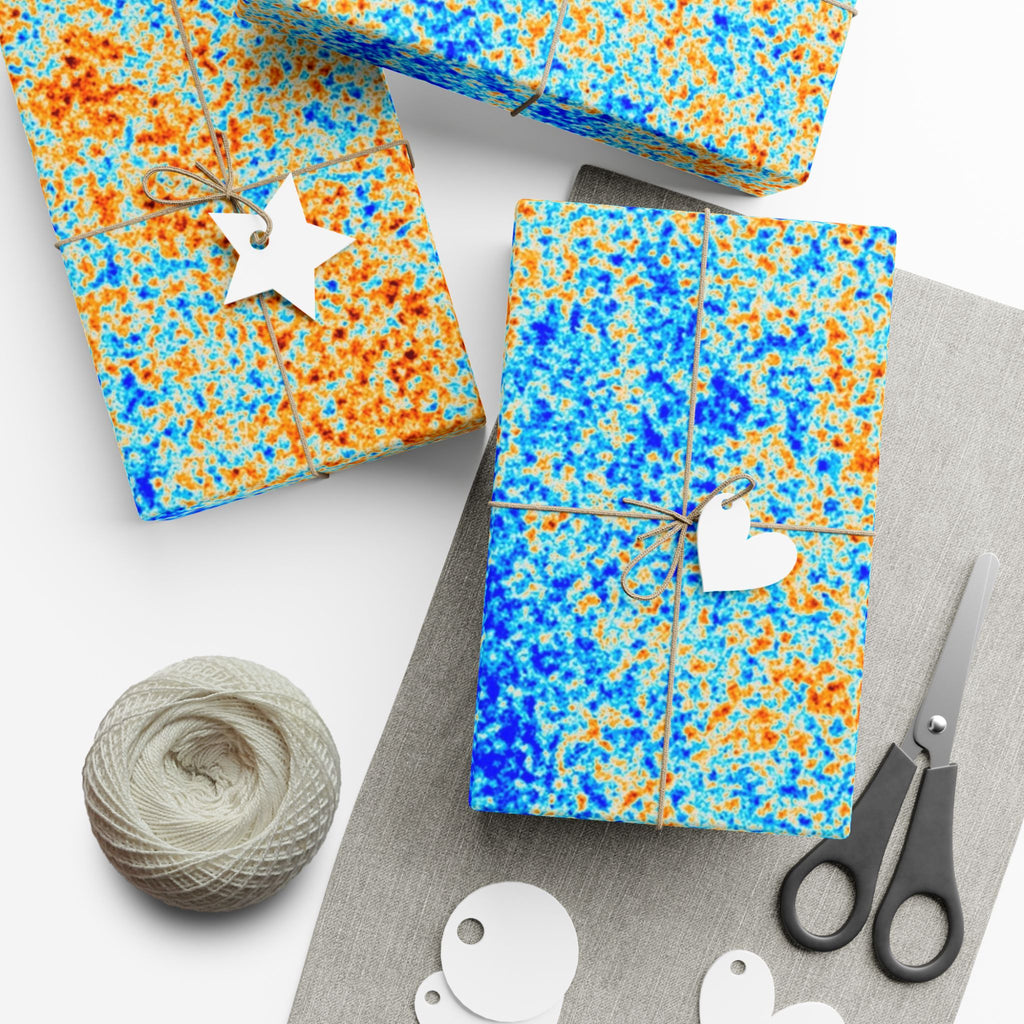 Gift boxes with blue and orange pattern of the cosmic microwave background yarn, and scissors on a white background
